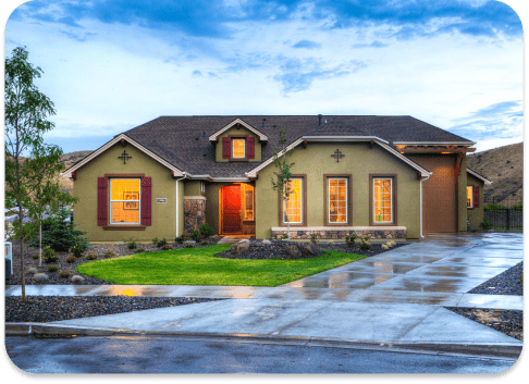 A single-storey home lit at dusk after an exterior repaint